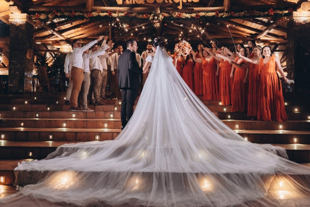bride & groom who stand out from the rest of the guests as they exit the venue together