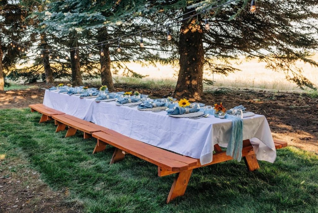picnic table with plate settings for people to experience a farm to table dinner at this event venue